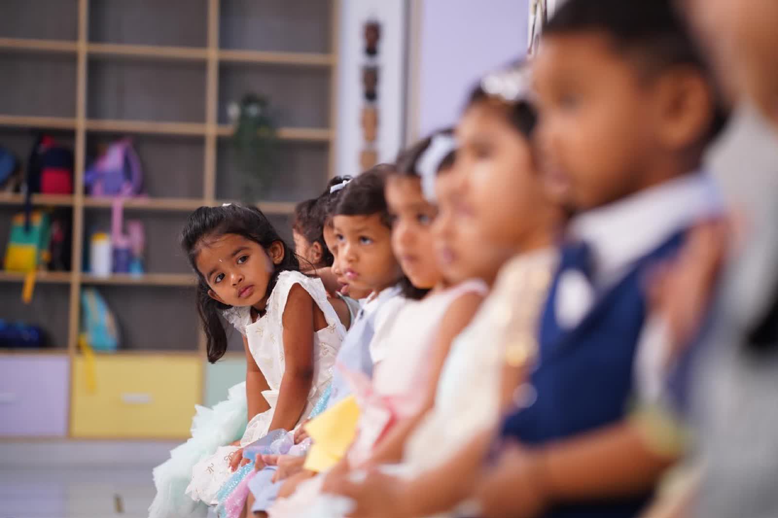A row of Bodhi Valley children waiting together in the classroom
